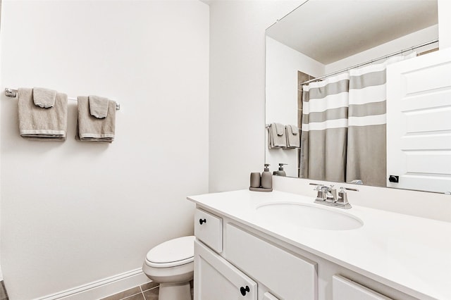 bathroom featuring tile patterned flooring, vanity, toilet, baseboards, and curtained shower