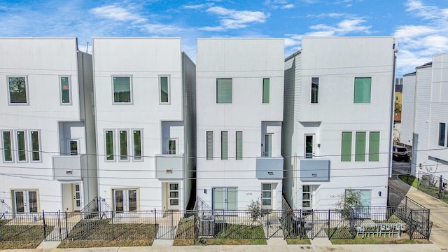 multi unit property featuring stucco siding and fence private yard