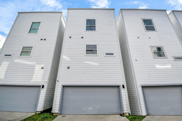 rear view of house featuring an attached garage