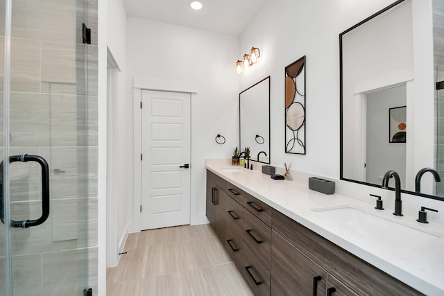 full bath featuring a shower stall, a sink, double vanity, and recessed lighting