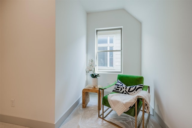 sitting room featuring baseboards and carpet floors