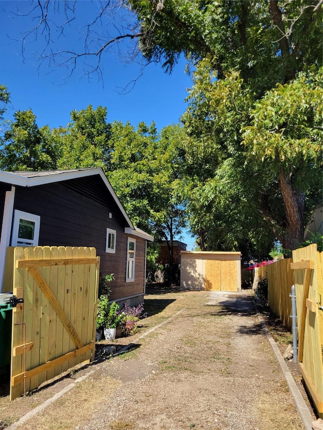 view of home's exterior featuring fence and dirt driveway