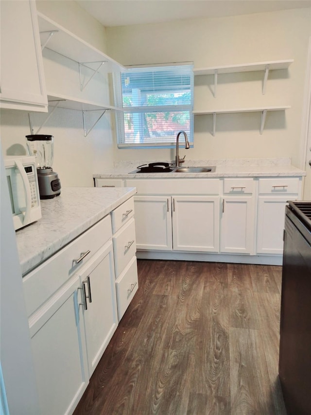 151 Canton, San Antonio, TX 78202 - kitchen featuring open shelves, white microwave, a sink, and white cabinetry