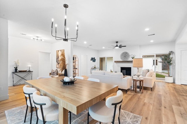 dining room featuring recessed lighting, ceiling fan with notable chandelier, visible vents, and light wood-type flooring