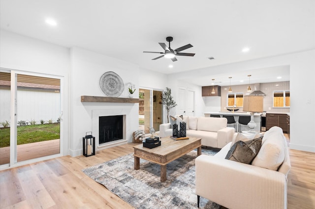 living room featuring recessed lighting, light wood-style floors, and ceiling fan