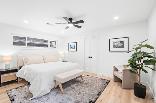 bedroom with recessed lighting, visible vents, a ceiling fan, light wood-type flooring, and a closet