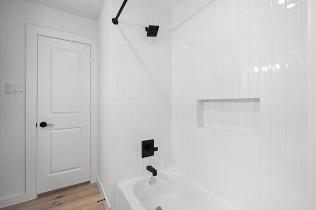 full bathroom featuring wood finished floors and  shower combination