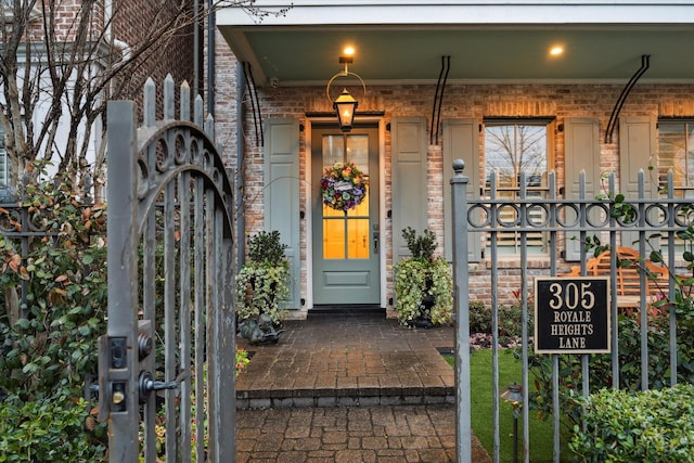 305 Royale Heights Ln, Houston, TX 77024 - view of exterior entry featuring brick siding and covered porch