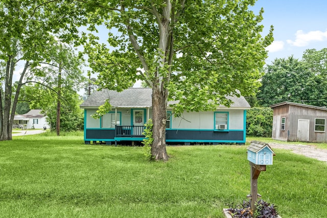 single story home with a shingled roof and a front yard