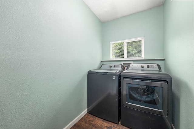 washroom with separate washer and dryer, laundry area, dark wood finished floors, and baseboards