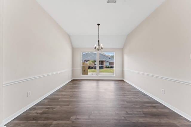 7103 Hot Creek Trce, Humble, TX 77346 - unfurnished dining area featuring dark wood finished floors, a chandelier, vaulted ceiling, and baseboards