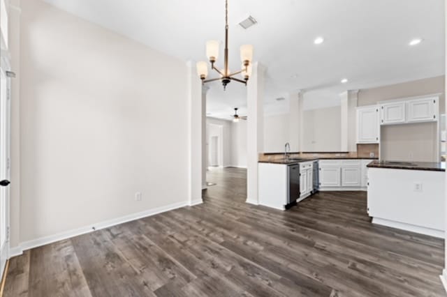 7103 Hot Creek Trce, Humble, TX 77346 - kitchen with dark countertops, dark wood-style flooring, a chandelier, white cabinets, and recessed lighting