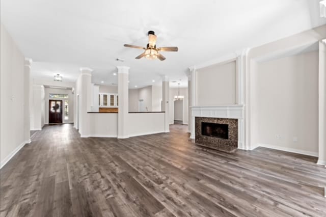 7103 Hot Creek Trce, Humble, TX 77346 - unfurnished living room featuring dark wood-type flooring, a large fireplace, ceiling fan, baseboards, and recessed lighting