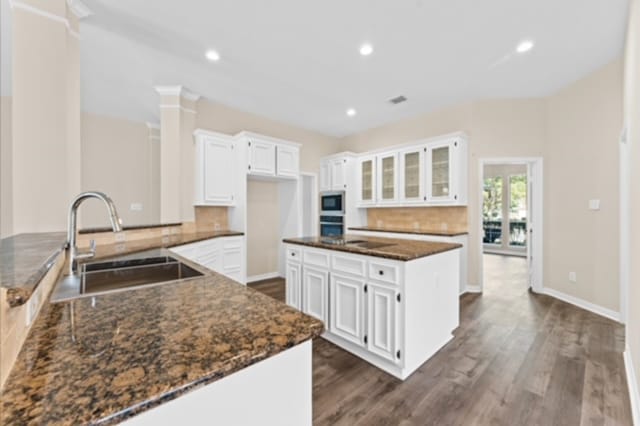 7103 Hot Creek Trce, Humble, TX 77346 - kitchen featuring a sink, white microwave, decorative backsplash, oven, and dark wood-style flooring