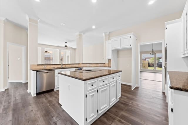 7103 Hot Creek Trce, Humble, TX 77346 - kitchen with stainless steel dishwasher, white cabinetry, dark wood finished floors, dark stone counters, and recessed lighting
