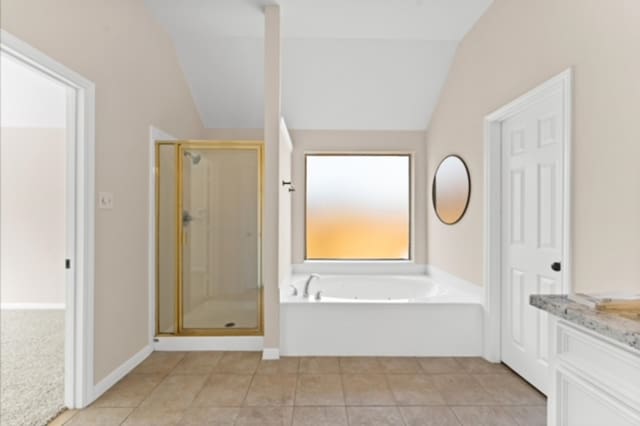 7103 Hot Creek Trce, Humble, TX 77346 - full bathroom with vaulted ceiling, a shower stall, a bath, tile patterned flooring, and vanity