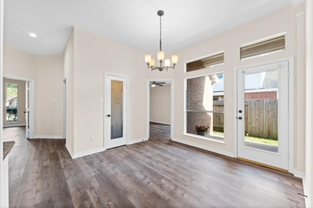 7103 Hot Creek Trce, Humble, TX 77346 - unfurnished dining area featuring a chandelier, wood finished floors, baseboards, and ceiling fan