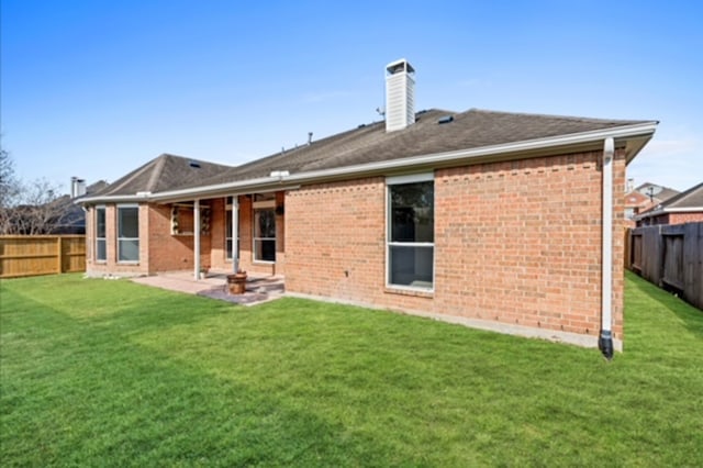 7103 Hot Creek Trce, Humble, TX 77346 - back of property featuring a chimney, brick siding, and a patio