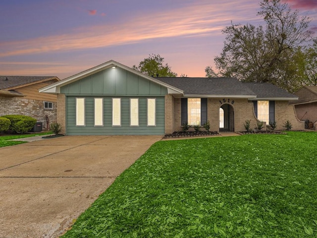1510 Tarberry Rd, Houston, TX 77088 - single story home with brick siding, a front lawn, board and batten siding, and concrete driveway