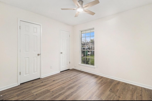 1510 Tarberry Rd, Houston, TX 77088 - empty room with dark wood-type flooring, ceiling fan, and baseboards