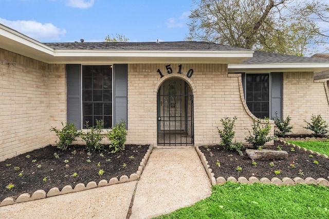 1510 Tarberry Rd, Houston, TX 77088 - doorway to property featuring brick siding and a shingled roof