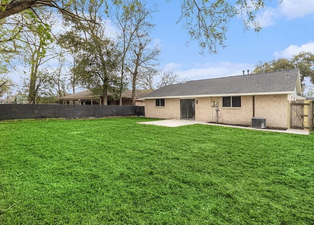 1510 Tarberry Rd, Houston, TX 77088 - rear view of house with central AC, a patio, brick siding, and a shingled roof