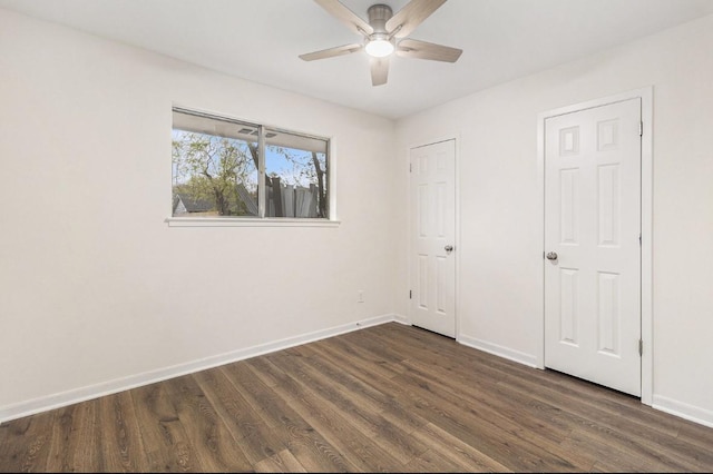 1510 Tarberry Rd, Houston, TX 77088 - unfurnished bedroom featuring dark wood-type flooring, baseboards, and a ceiling fan