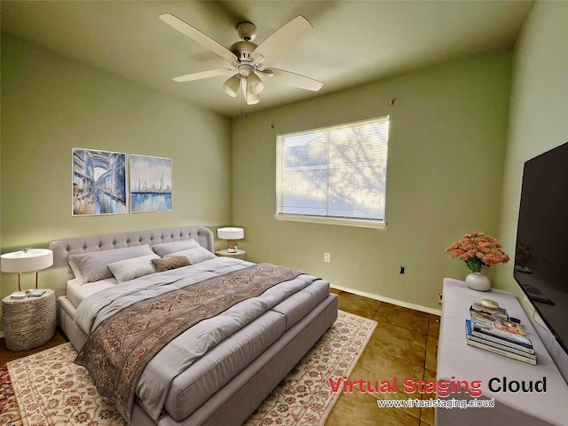 bedroom with tile patterned floors, baseboards, and a ceiling fan