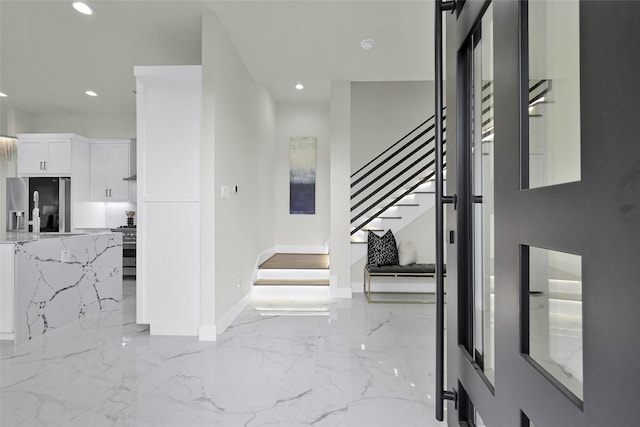 foyer featuring stairway, recessed lighting, and marble finish floor