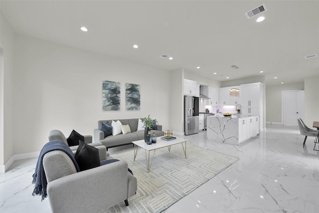 living area with visible vents, recessed lighting, marble finish floor, and baseboards