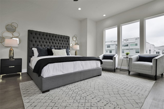 bedroom with recessed lighting, wood finished floors, and baseboards