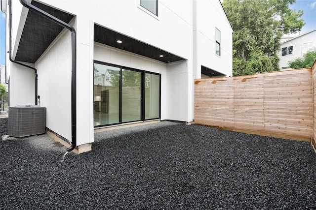rear view of house featuring fence, a patio, cooling unit, and stucco siding