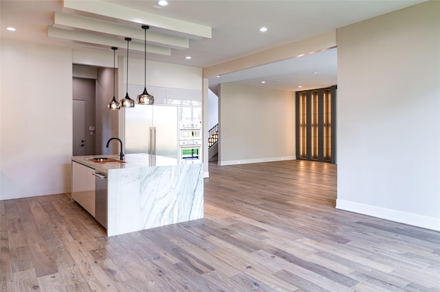 2222 Branard St, Houston, TX 77098 - kitchen with modern cabinets, a sink, stainless steel appliances, and light wood-style floors