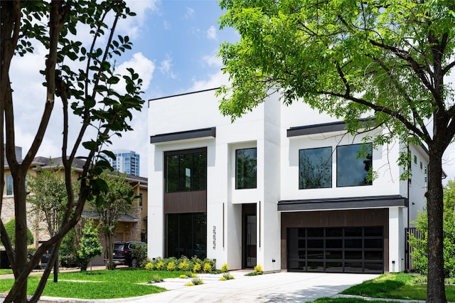 2222 Branard St, Houston, TX 77098 - view of front facade featuring stucco siding, driveway, and an attached garage