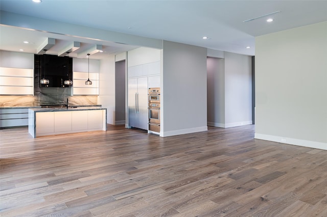 2222 Branard St, Houston, TX 77098 - unfurnished living room featuring baseboards, recessed lighting, and wood finished floors