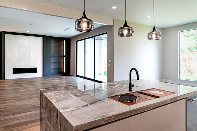 2222 Branard St, Houston, TX 77098 - kitchen featuring recessed lighting, wood finished floors, white cabinetry, pendant lighting, and open floor plan