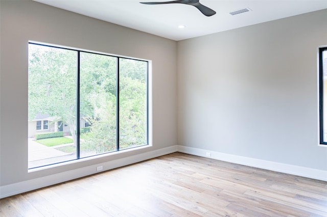 2222 Branard St, Houston, TX 77098 - unfurnished room with baseboards, light wood-style flooring, and a healthy amount of sunlight