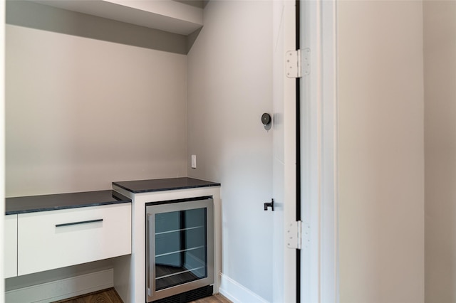 2222 Branard St, Houston, TX 77098 - bar featuring beverage cooler and wood finished floors