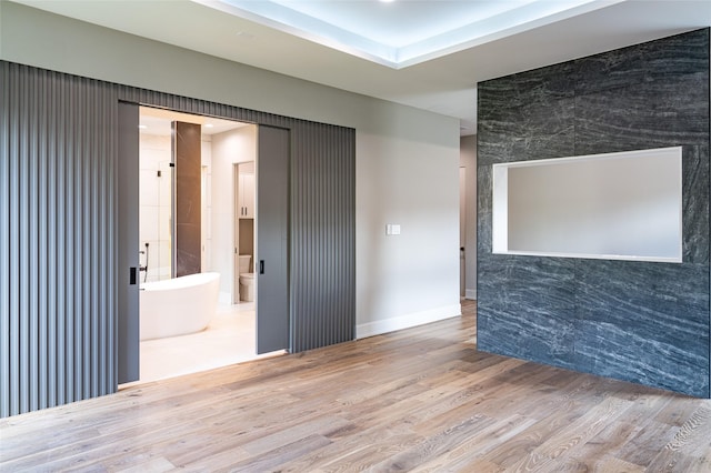 2222 Branard St, Houston, TX 77098 - empty room featuring an accent wall and wood finished floors
