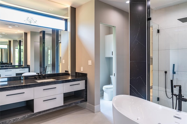 2222 Branard St, Houston, TX 77098 - bathroom featuring toilet, vanity, a wealth of natural light, and a soaking tub
