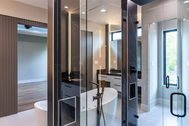 2222 Branard St, Houston, TX 77098 - full bath featuring a freestanding bath, a shower stall, vanity, and baseboards