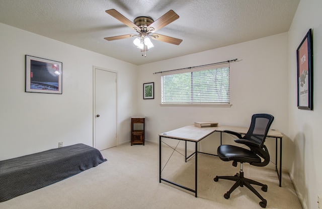 office space featuring ceiling fan, a textured ceiling, and light colored carpet