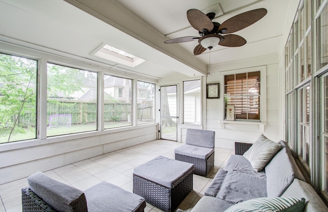 sunroom with a ceiling fan, outdoor lounge area, plenty of natural light, and beam ceiling