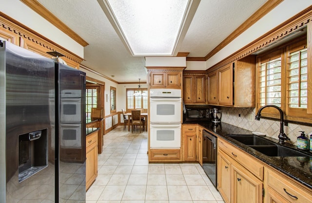 kitchen featuring a textured ceiling, crown molding, a sink, light tile patterned floors, and black appliances