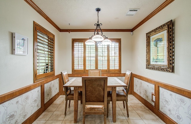 dining area with visible vents, ornamental molding, wainscoting, and light tile patterned flooring