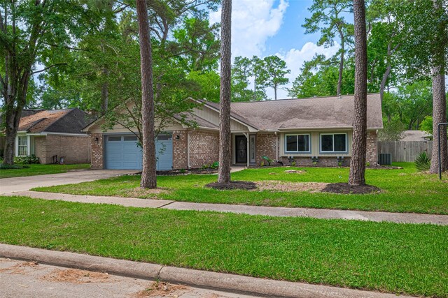 14823 Forest Lodge Dr, Houston, TX 77070 - ranch-style house featuring brick siding, a garage, fence, and driveway