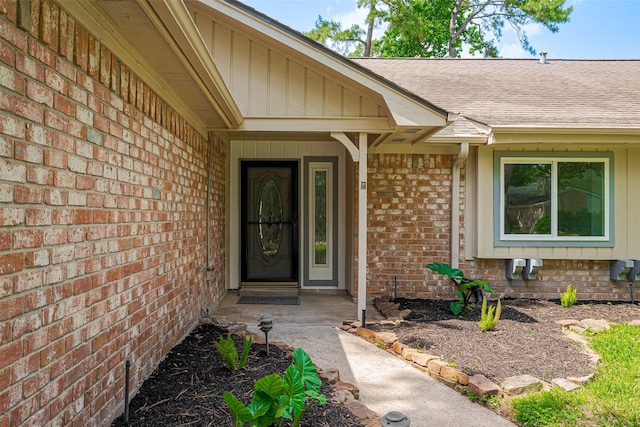 14823 Forest Lodge Dr, Houston, TX 77070 - doorway to property featuring a shingled roof and brick siding