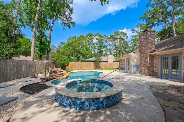 14823 Forest Lodge Dr, Houston, TX 77070 - view of swimming pool with french doors, a fenced backyard, a pool with connected hot tub, and a patio area