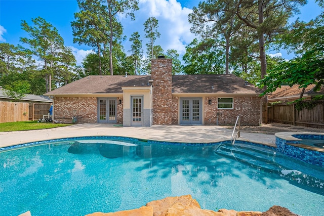 14823 Forest Lodge Dr, Houston, TX 77070 - view of pool featuring a fenced backyard, a patio area, a pool with connected hot tub, and french doors