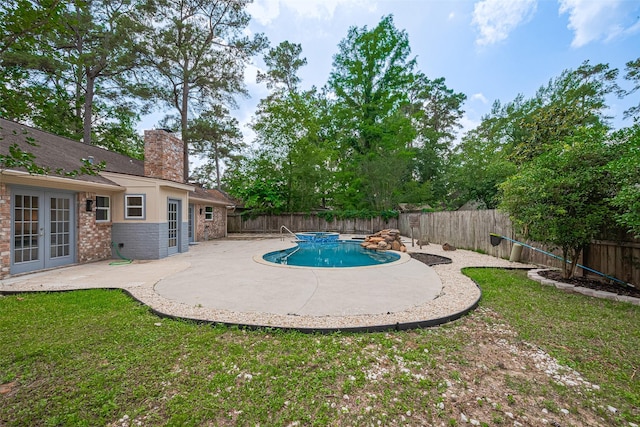 14823 Forest Lodge Dr, Houston, TX 77070 - view of swimming pool with french doors, a lawn, a patio area, a fenced in pool, and a fenced backyard